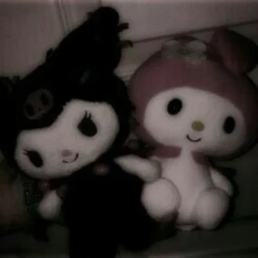 two plushies cuddling next to each other