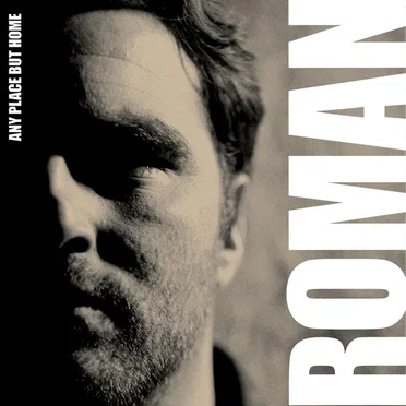 Any Place But Home by Roman - album cover