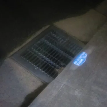 Storm Drain With a Small Amount of Water in Richmond at Night (Cellphone Field)